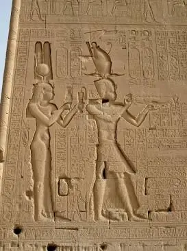 Historical stone relief carved on the exterior wall of the Temple of Hathor in Dendera, Egypt, showing Cleopatra VII and her son Caesarion making offerings.