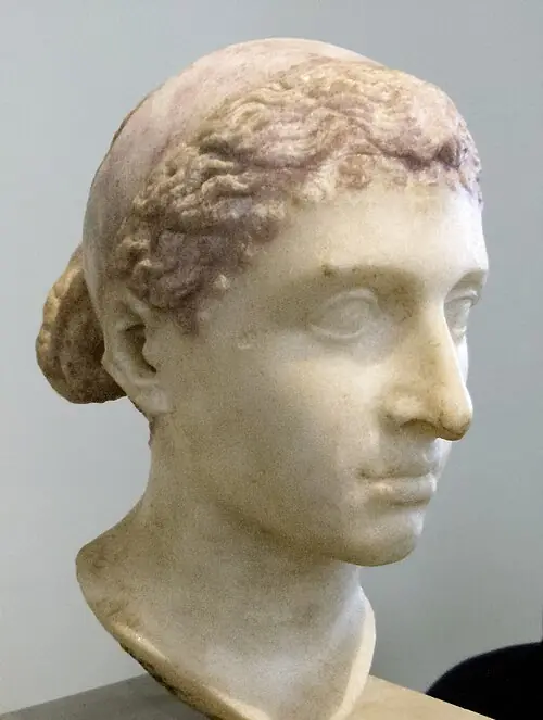 Marble bust of Cleopatra VII at the Altes Museum showing her real facial features, a prominent aquiline nose, and the classical melon coiffure hairstyle.