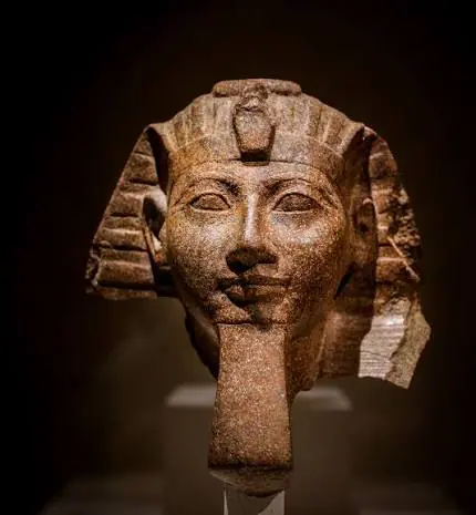 Bust of Queen Hatshepsut depicted as a male pharaoh wearing the ceremonial false beard and royal headdress