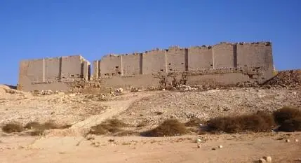 Ruined stone exterior walls of the ancient Taposiris Magna temple in Egypt, the primary excavation site for Cleopatra's tomb.
